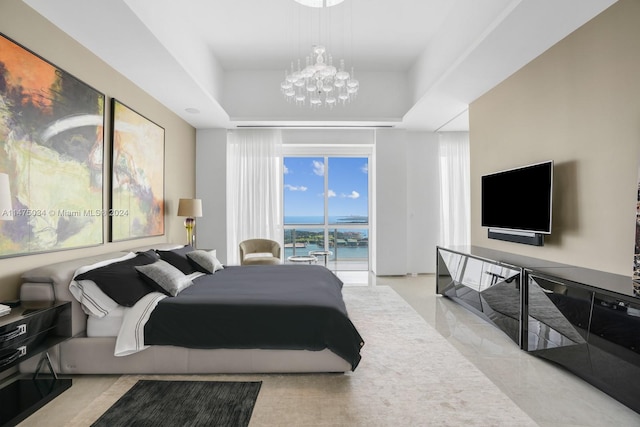 bedroom featuring a notable chandelier, a water view, access to exterior, and a raised ceiling