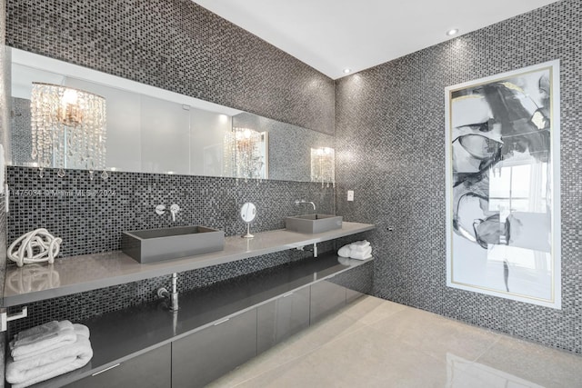 bathroom featuring backsplash, dual bowl vanity, tile walls, and tile floors