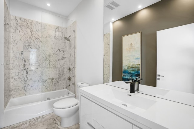 full bathroom featuring tile flooring, toilet, vanity, and tiled shower / bath