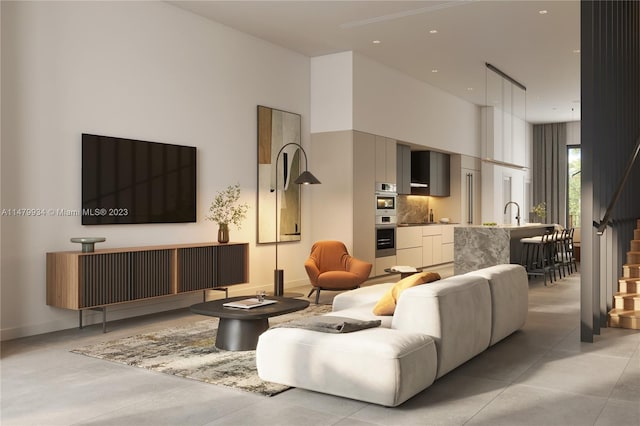 tiled living room featuring sink and a towering ceiling