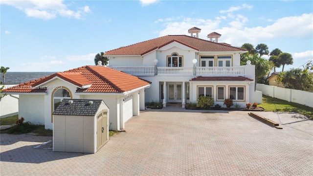 rear view of house with a garage and a balcony