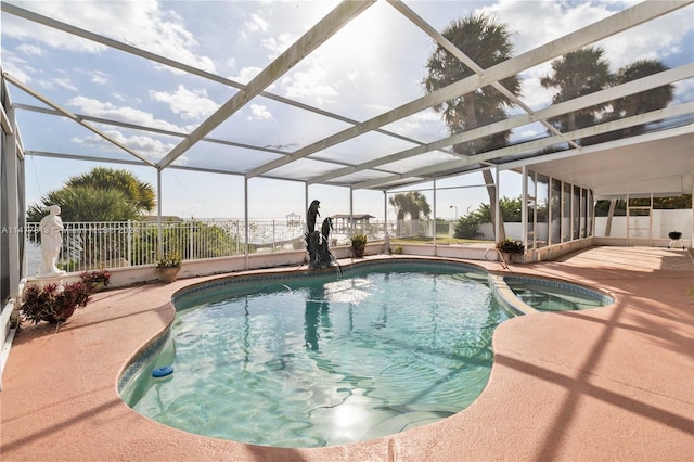 view of swimming pool with a patio area and a lanai