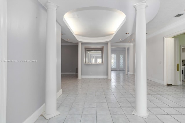 interior space with ornate columns and a raised ceiling