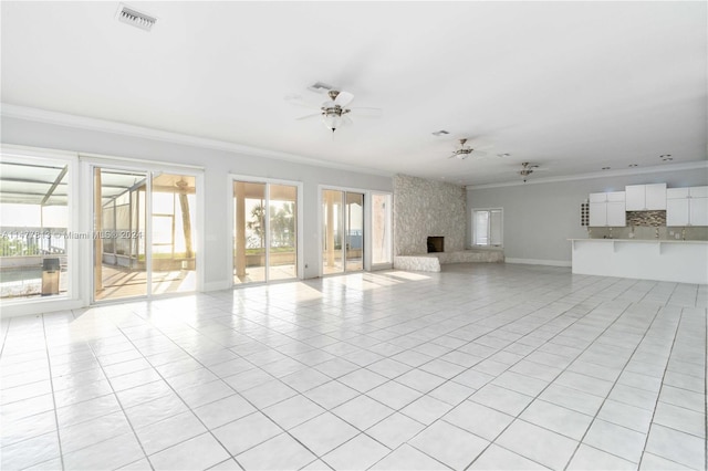 unfurnished living room with ceiling fan, ornamental molding, light tile patterned floors, and a high end fireplace