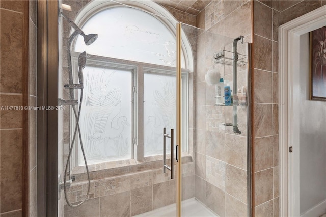 bathroom featuring a shower with shower door