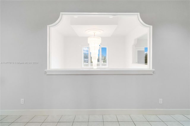 interior details featuring an inviting chandelier and tile patterned flooring