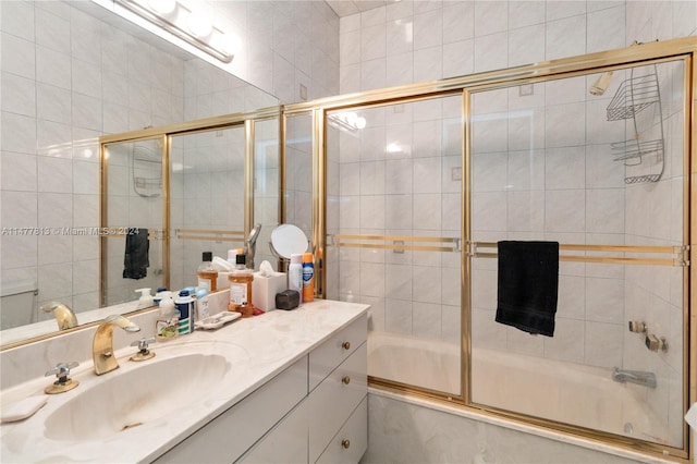 bathroom with bath / shower combo with glass door and vanity