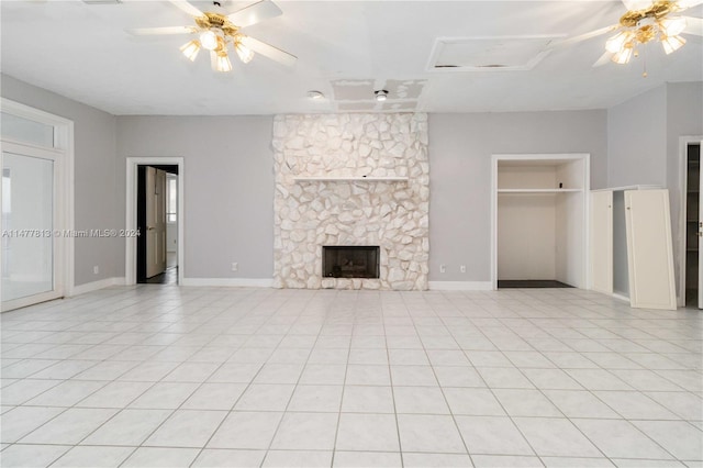 unfurnished living room featuring ceiling fan, light tile patterned flooring, and a fireplace