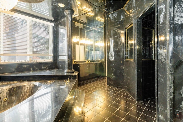 bathroom with vanity, a tub to relax in, and tile patterned flooring