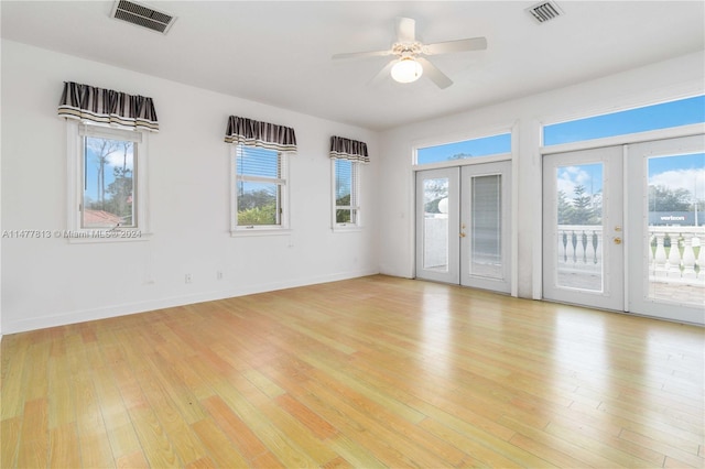 spare room with french doors, ceiling fan, and light hardwood / wood-style flooring