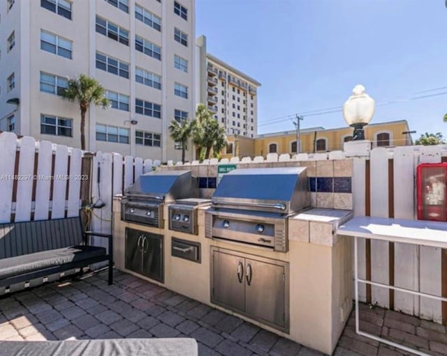 view of patio featuring area for grilling and a grill