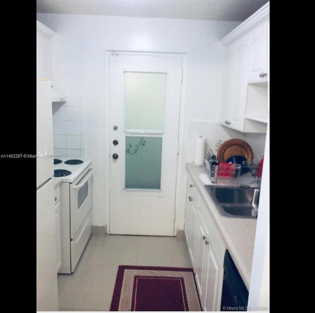 kitchen featuring sink, white cabinetry, white electric range oven, and light tile flooring