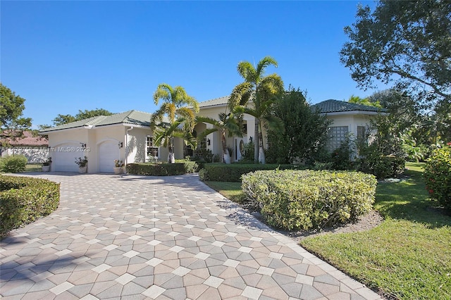 mediterranean / spanish-style house with a front lawn and a garage