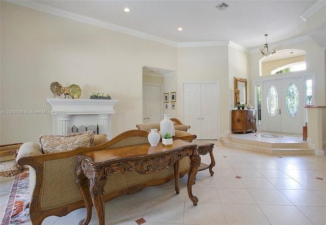 tiled living room featuring a high ceiling, a notable chandelier, and crown molding