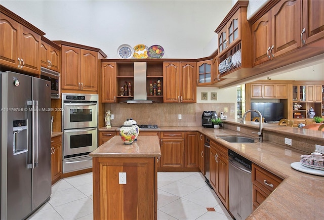 kitchen with wall chimney range hood, tasteful backsplash, appliances with stainless steel finishes, and light tile floors