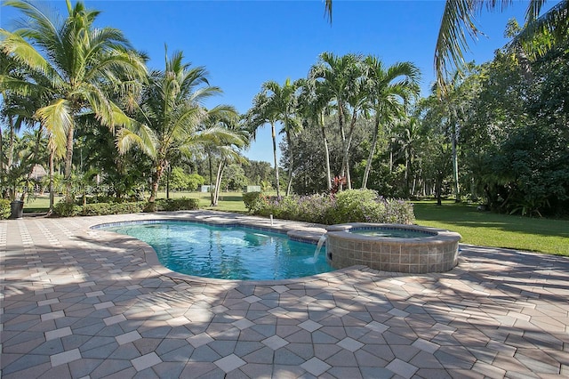 view of pool featuring a lawn, an in ground hot tub, pool water feature, and a patio