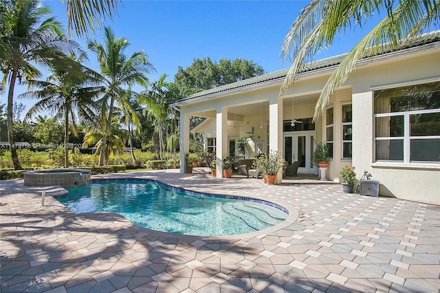 view of swimming pool with a patio area and an in ground hot tub