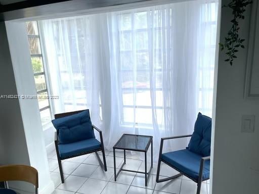 living area featuring light tile flooring