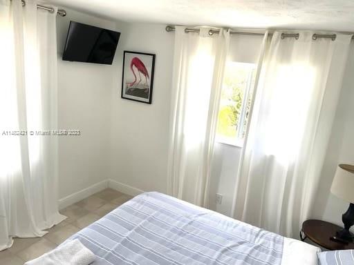 bedroom with light tile flooring