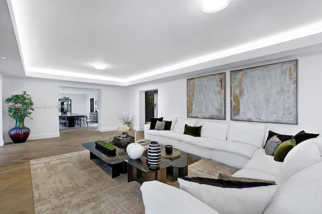 living room featuring parquet floors and a raised ceiling