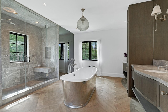 bathroom with parquet floors, vanity, and independent shower and bath