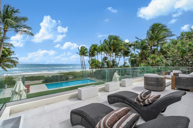 view of patio / terrace with a water view and an outdoor living space