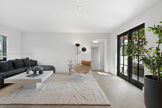 living room with french doors and hardwood / wood-style floors