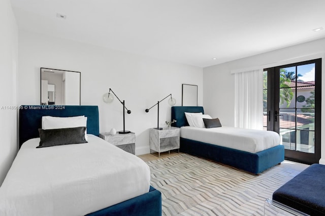 bedroom featuring access to exterior, french doors, and hardwood / wood-style flooring