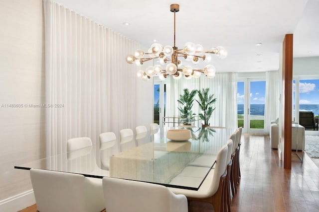 dining room with hardwood / wood-style flooring and a notable chandelier