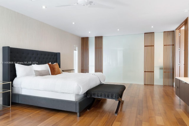 bedroom with ceiling fan and light hardwood / wood-style floors