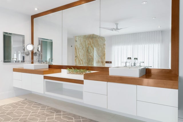 bathroom featuring double sink vanity and ceiling fan