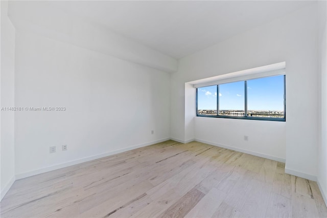 spare room with light hardwood / wood-style flooring