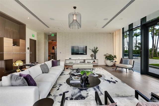 living room with floor to ceiling windows and hardwood / wood-style flooring