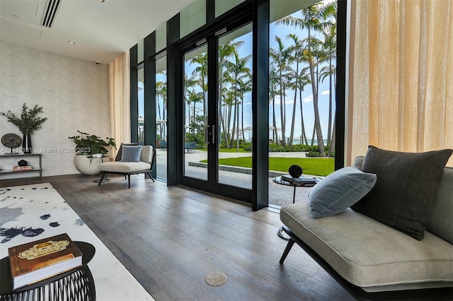 interior space with floor to ceiling windows, dark wood-type flooring, and french doors