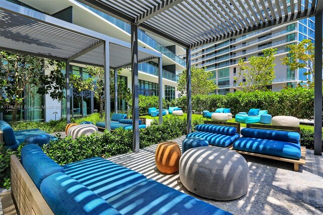 view of terrace with a balcony, outdoor lounge area, and a pergola