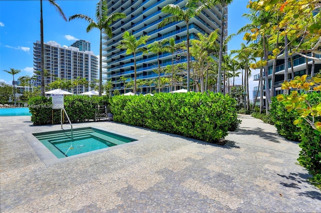 view of swimming pool featuring a community hot tub