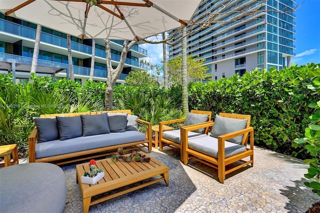 view of patio with a balcony and outdoor lounge area