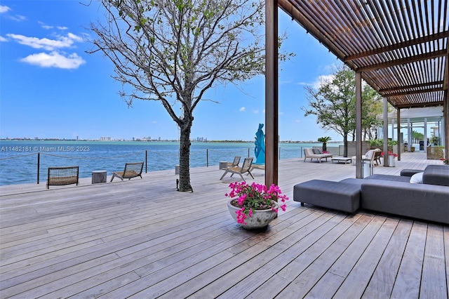 wooden terrace with a water view and a pergola