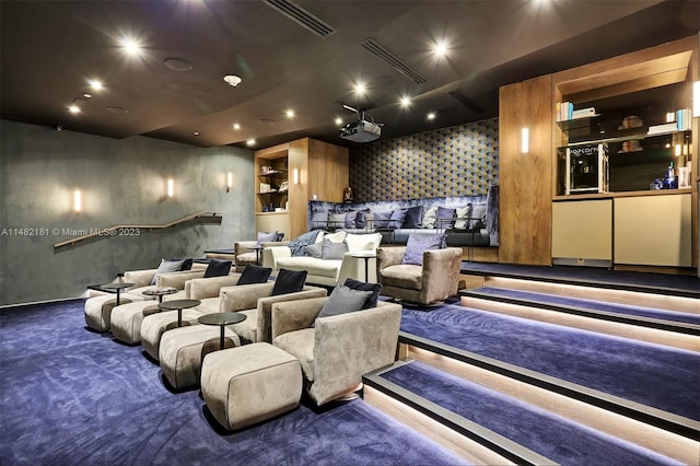 cinema room featuring dark colored carpet and built in shelves