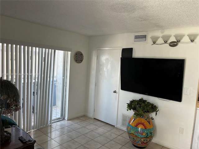 living room featuring a textured ceiling and light tile flooring