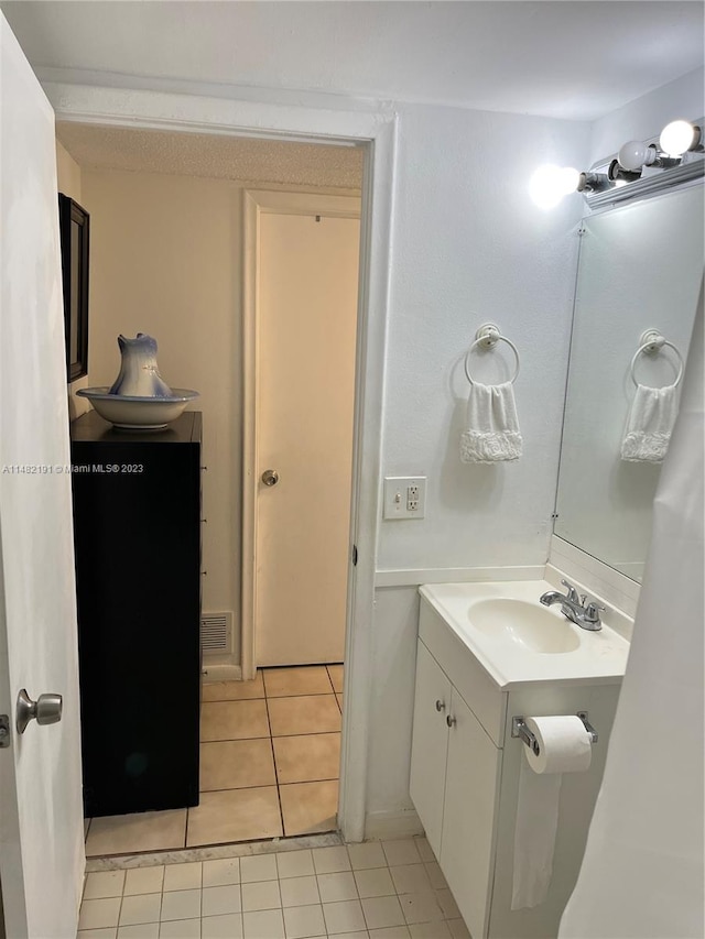 bathroom featuring tile floors and vanity