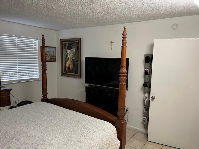 tiled bedroom with a textured ceiling