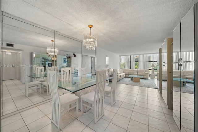 dining area with a textured ceiling, a wall of windows, a chandelier, and light tile patterned flooring