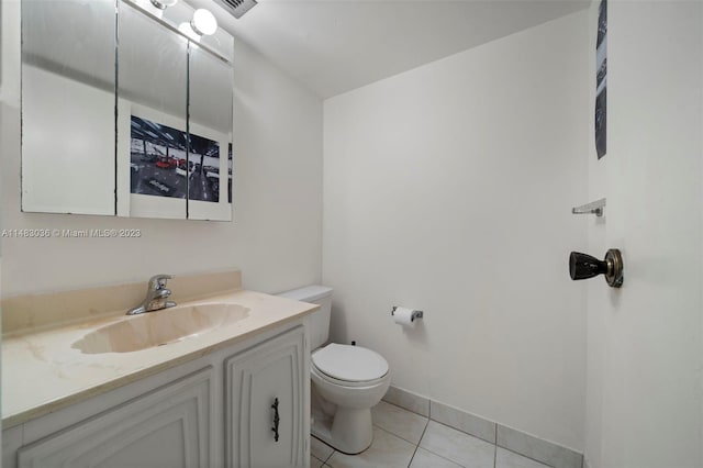 bathroom with vanity, tile patterned floors, and toilet