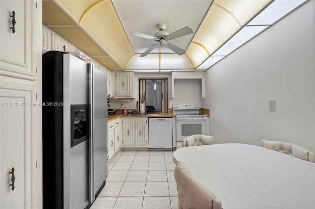 kitchen featuring white cabinetry, white appliances, and wood counters