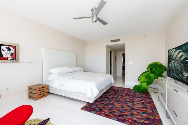 tiled bedroom featuring ceiling fan