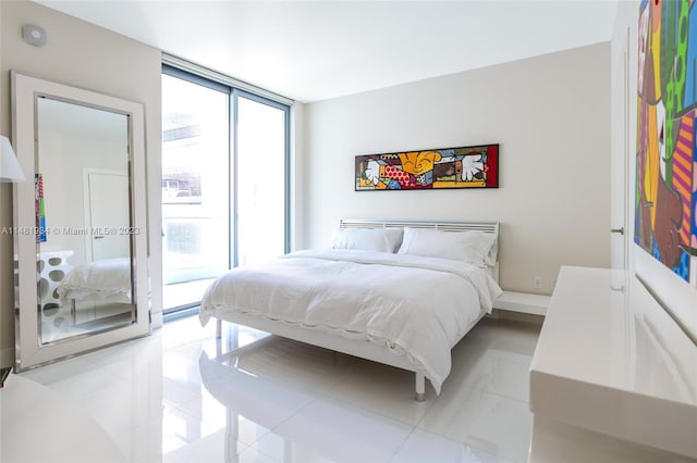 tiled bedroom featuring access to outside and floor to ceiling windows