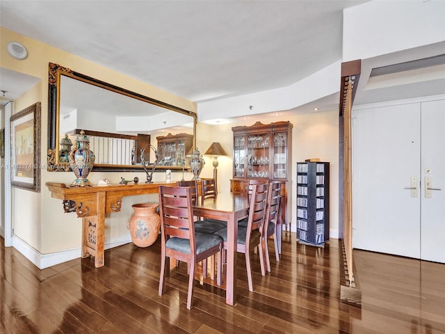 dining room with dark wood-type flooring