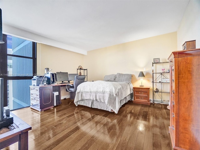 bedroom with a baseboard radiator and hardwood / wood-style floors