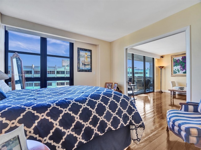 bedroom featuring hardwood / wood-style flooring and access to outside